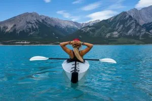 A solo traveller relaxing during a kayaking trip